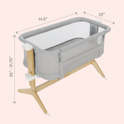 The Newton Baby Bundle 3 BFCM bassinet features a gray and white design with breathable mesh sides, wooden legs, and adjustable height from 26 to 31.75 inches. Dimensions: 41.5” L x 22” W.