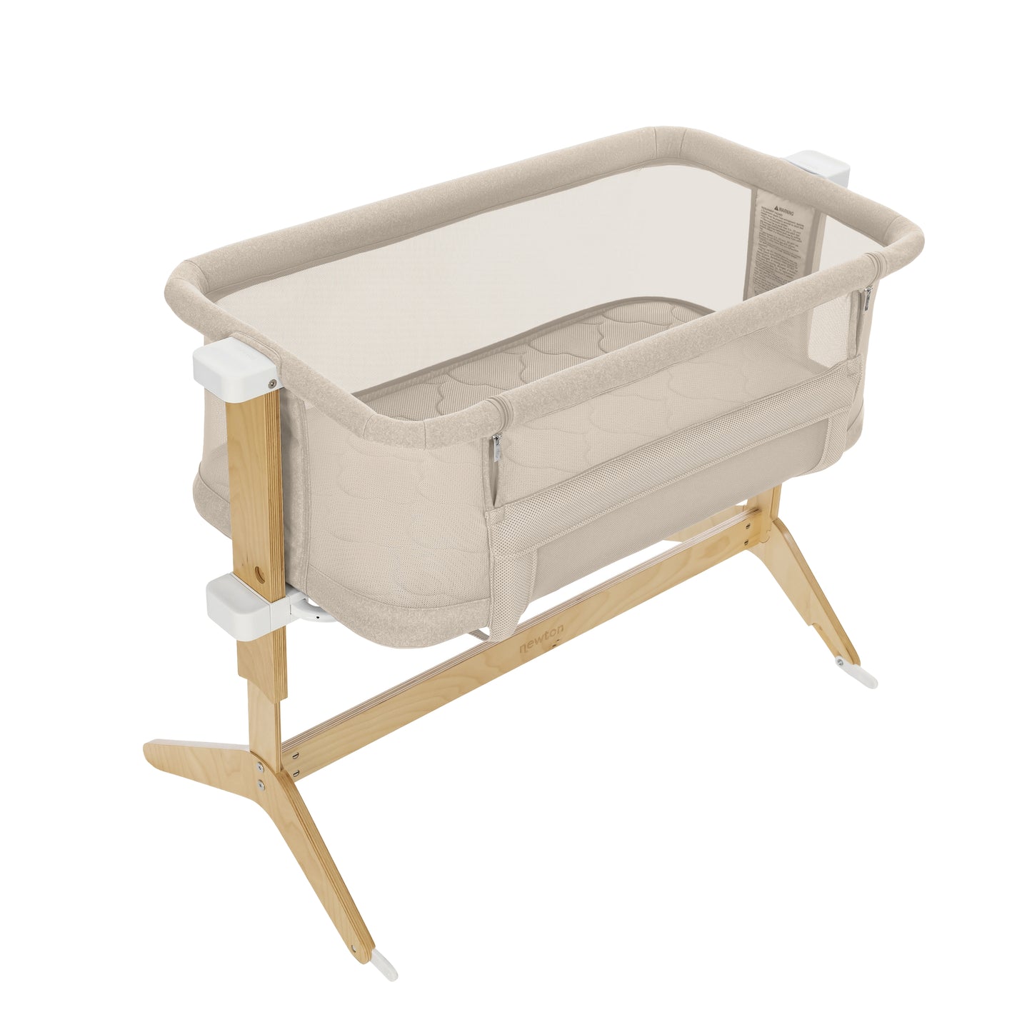 The Newton Baby Bassinet & Bedside Sleeper features mesh sides and a quilted Wovenaire mattress, supported by a light wood frame with white connectors and stable wooden legs.
