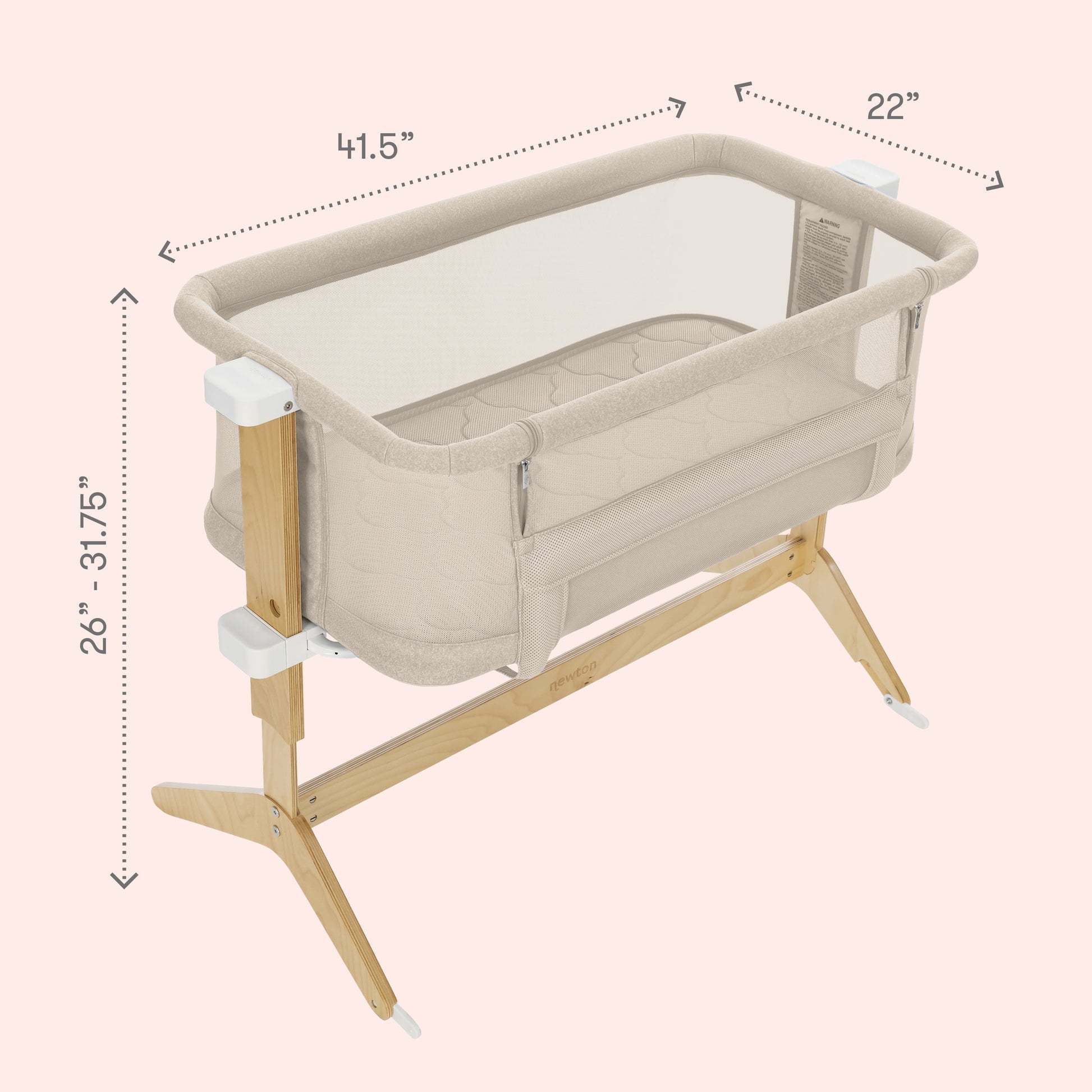 The Newton Baby Bassinet & Bedside Sleeper features breathable mesh sides, wooden legs, and a Wovenaire mattress. Adjustable height from 26"–31.75", it measures 41.5"x22". Cozy for your baby as a bedside sleeper on a light pink background.
