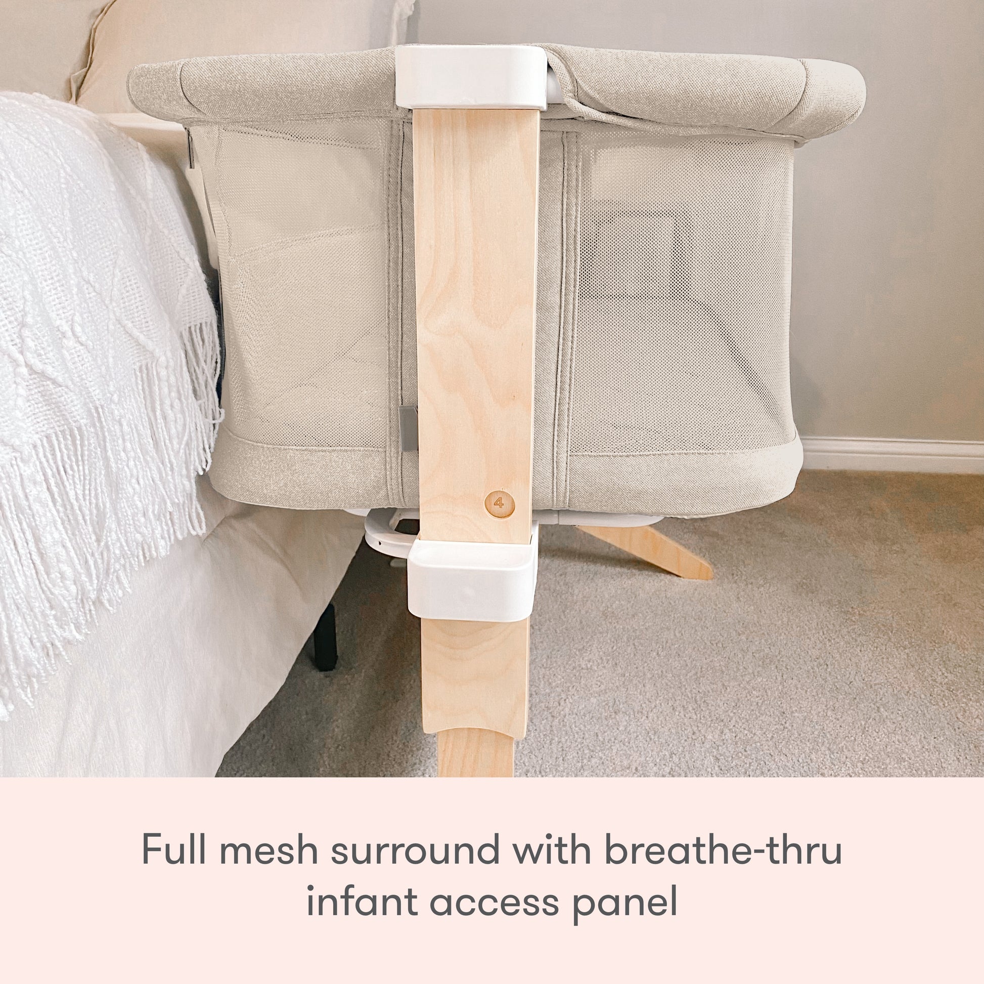 The Newton Baby Bassinet & Bedside Sleeper features a breathable beige design with full mesh sides, a wooden frame, and an easy-access infant panel—perfect for convenient use next to your bed.
