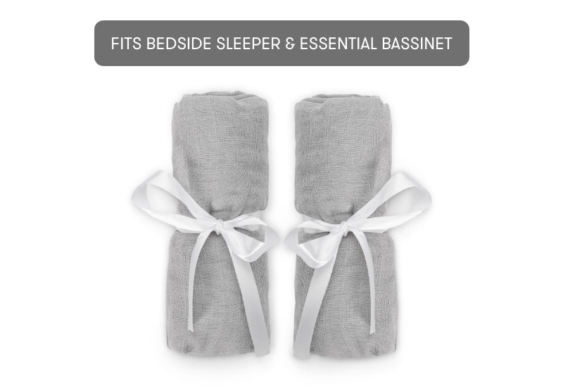 bassinet extra sheets wrapped in ribbons on white background with text, "fits bedside sleeper and essential bassinet"