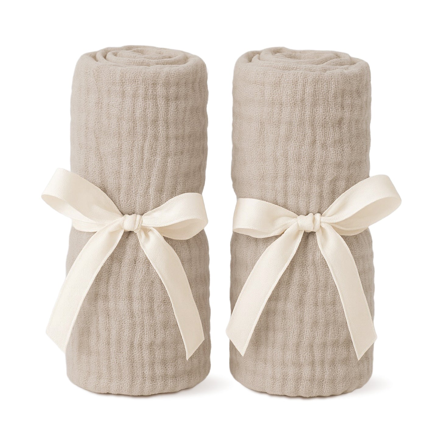 Two beige, textured blankets tied with cream ribbon bows stand upright side by side—an ideal pairing with Newton Baby Bassinet Extra Sheets for your bassinet or bedside sleeper. 999-8401-SAN