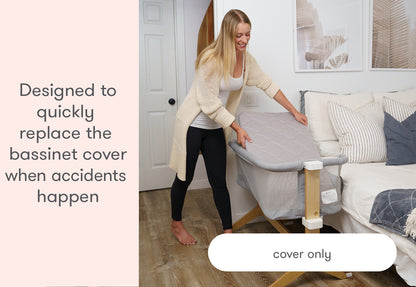 A woman replacing a bassinet cover with text stating "Designed to quickly replace the bassinet cover when accidents happen - cover only".