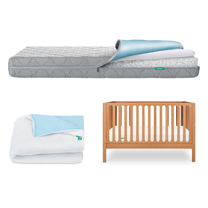The Newton Baby Galileo Crib, Waterproof Mattress & Pad Set features a wooden convertible crib with a waterproof mattress and blue and white cover—perfectly arranged for your nursery.