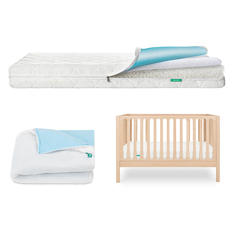 The Newton Baby Galileo Crib, Waterproof Mattress & Pad Set features a light wood convertible crib, a white waterproof mattress with a blue and white topper, and a folded blue and white blanket, all set against a bright white background.