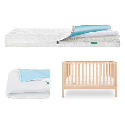 The Newton Baby Galileo Crib, Waterproof Mattress & Pad Set features a light wood convertible crib, a white waterproof mattress with a blue and white topper, and a folded blue and white blanket, all set against a bright white background.