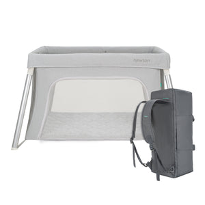 The Newton Baby Compact Travel Crib & Play Yard in light gray features mesh sides for breathability and includes a matching dark gray carrying backpack, making it easy to transport.