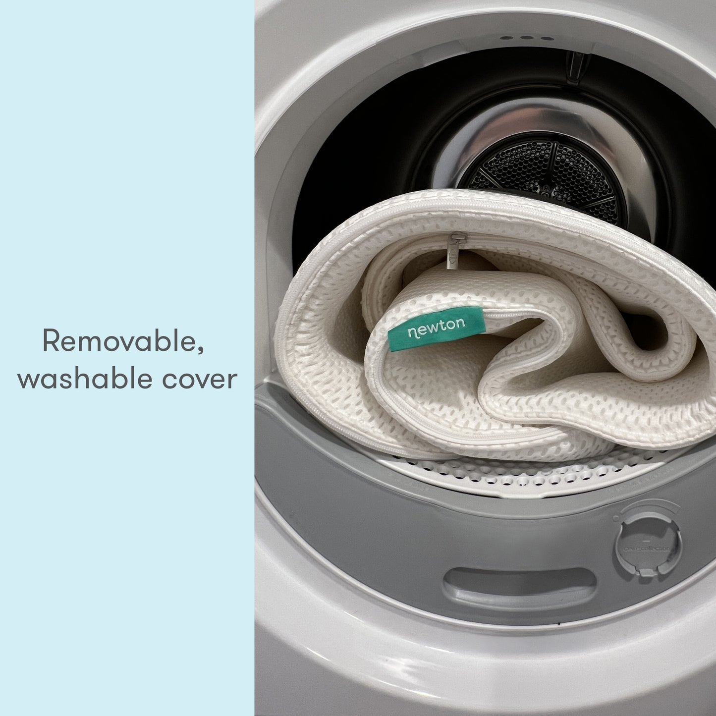 A Newton baby mattress cover with a tag, coiled inside a washing machine, depicting its removable and washable feature, accompanied by the text "Removable, washable cover."