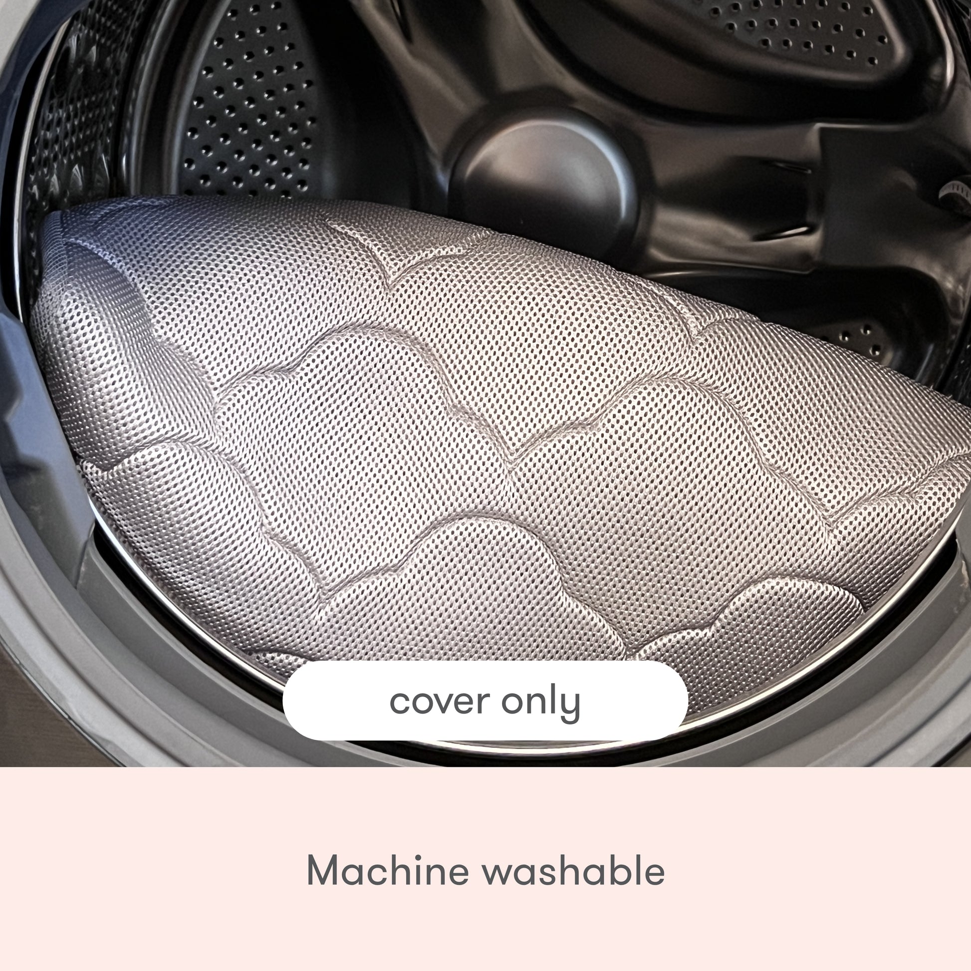 The Newton Baby Extra Bassinet Mattress Cover, featuring a quilted cloud pattern, is placed in a front-loading washing machine. Text on the image reads "cover only" and "machine washable.