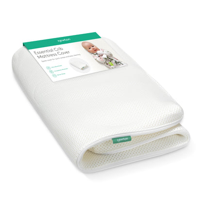 A folded white Extra Essential Crib Mattress Cover by Newton Baby is shown with packaging that features a smiling baby and highlights its waterproof, washable design, ultra-breathability, and compatibility with most cribs.