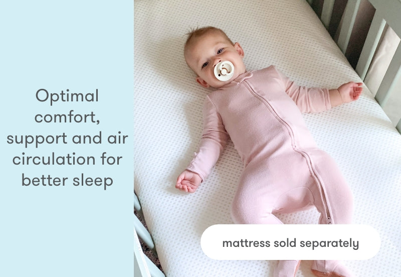 Baby in a pink onesie with pacifier lies on a breathable mattress with text 'Optimal comfort, support and air circulation for better sleep' and 'mattress sold separately'.
