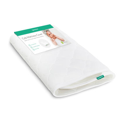 A folded, white, washable Extra Original Crib Mattress Cover by Newton Baby is shown in packaging featuring a baby and green-and-white label that highlights its breathable design and displays the Newton Baby logo.