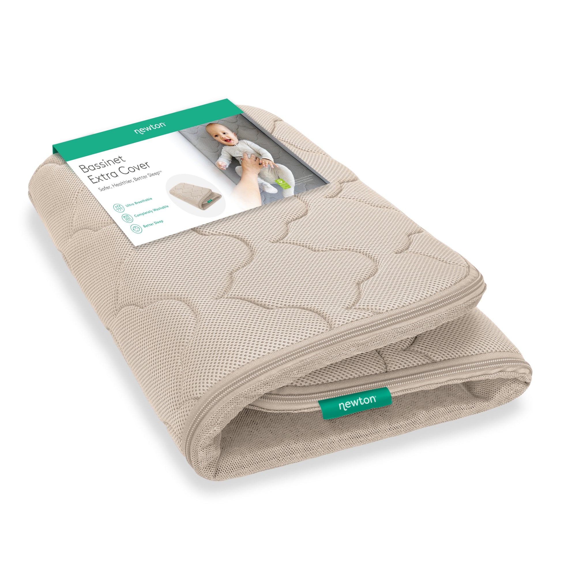 A folded beige Newton Baby Extra Bassinet Mattress Cover with a green and white label showing a smiling baby and details. The “newton” tag is visible. This cover is machine washable. 999-4400-SAN