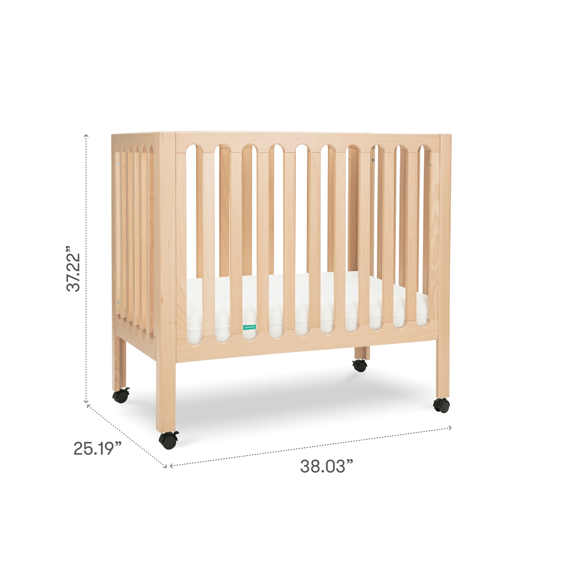 The Newton Galileo Mini Crib with Newton Mattress by Newton Baby features natural beech wood, vertical slats, a white mattress, and four black caster wheels. It measures 37.22"H x 38.03"W x 25.19"D, perfect as a portable crib for any nursery.