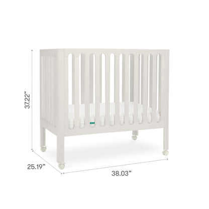 Newton Galileo Mini Crib with Newton Mattress by Newton Baby: Portable crib with vertical slats, cozy mattress, and four wheels. Made from beech wood; 37.22" H x 25.19" W x 38.03" L—ideal for small spaces or travel.