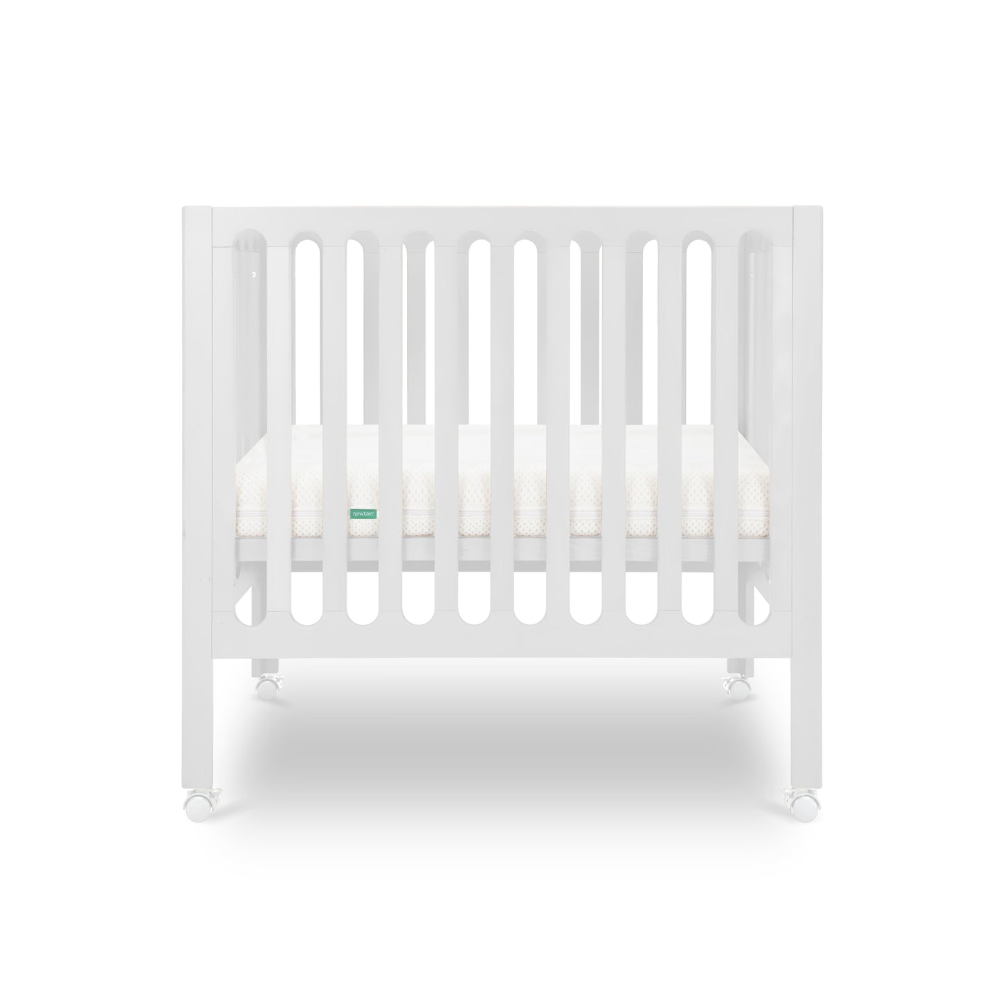 The Newton Baby Galileo Mini Crib with Newton Mattress features vertical slats, a comfy mattress, and four wheels. Crafted from durable beech wood, this portable white crib appears against a clean white background.