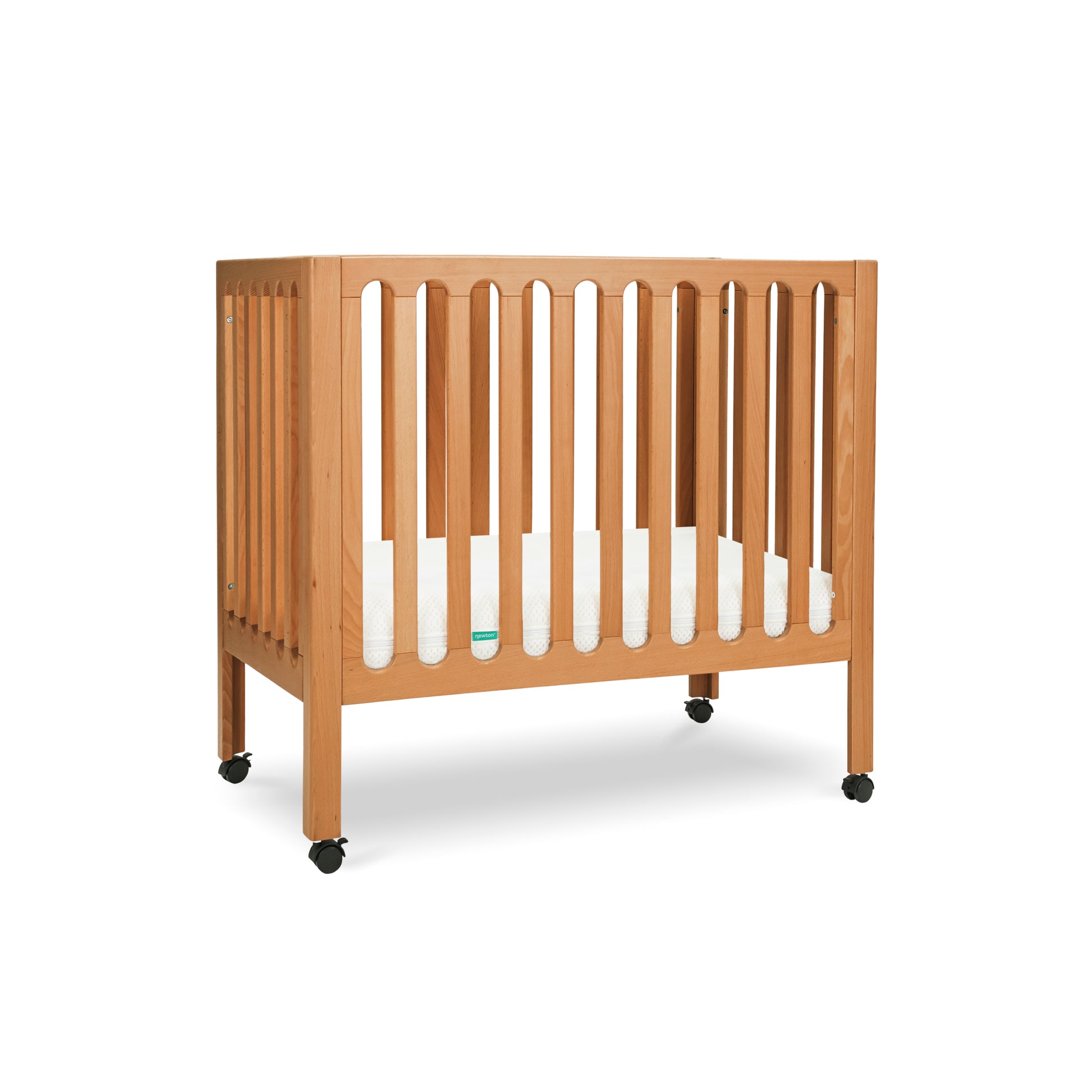 Modern wooden crib on wheels with visible mattress, isolated on a white background. 999-8430-CST