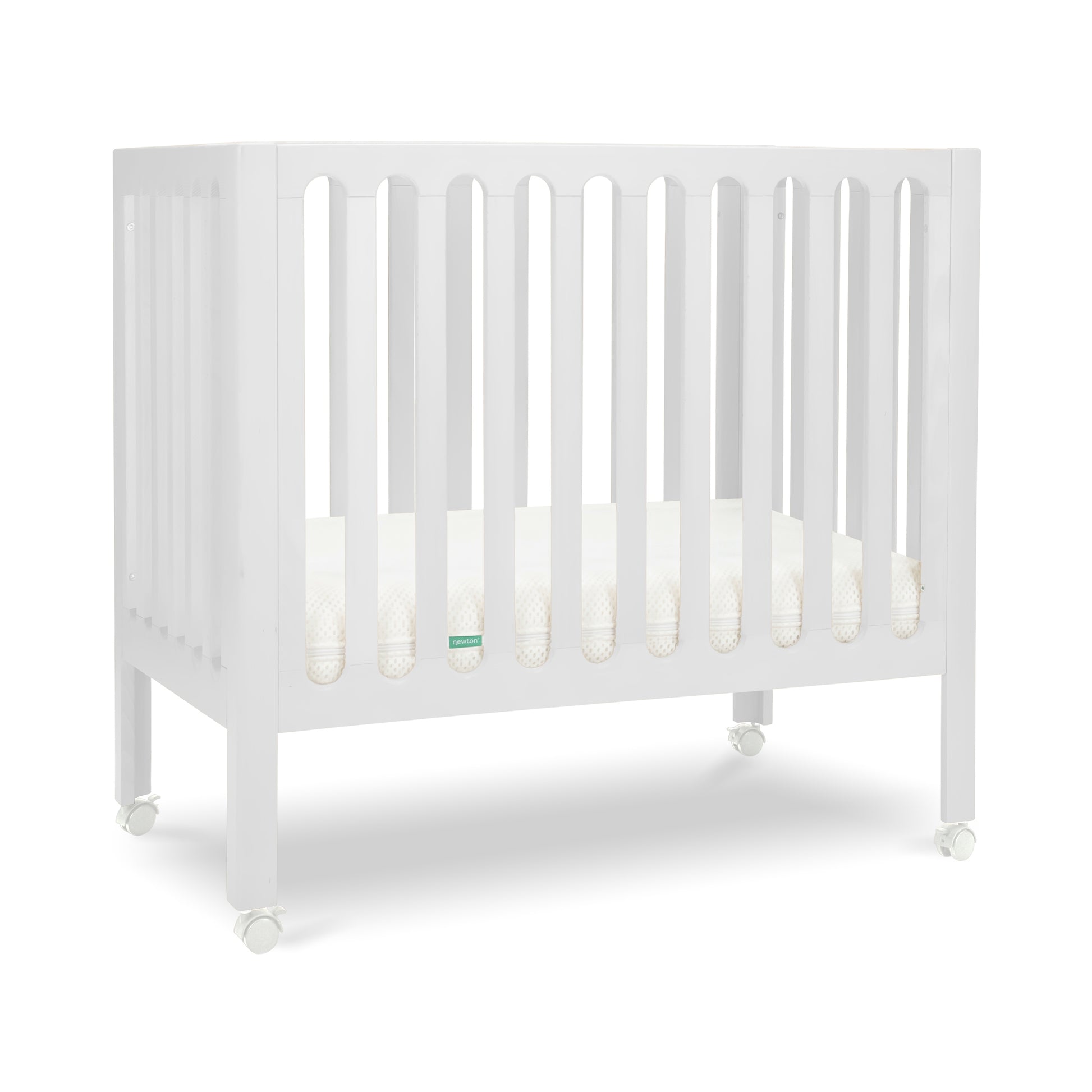 White modern crib on wheels with visible mattress, isolated on a plain background. 999-8430-WHT