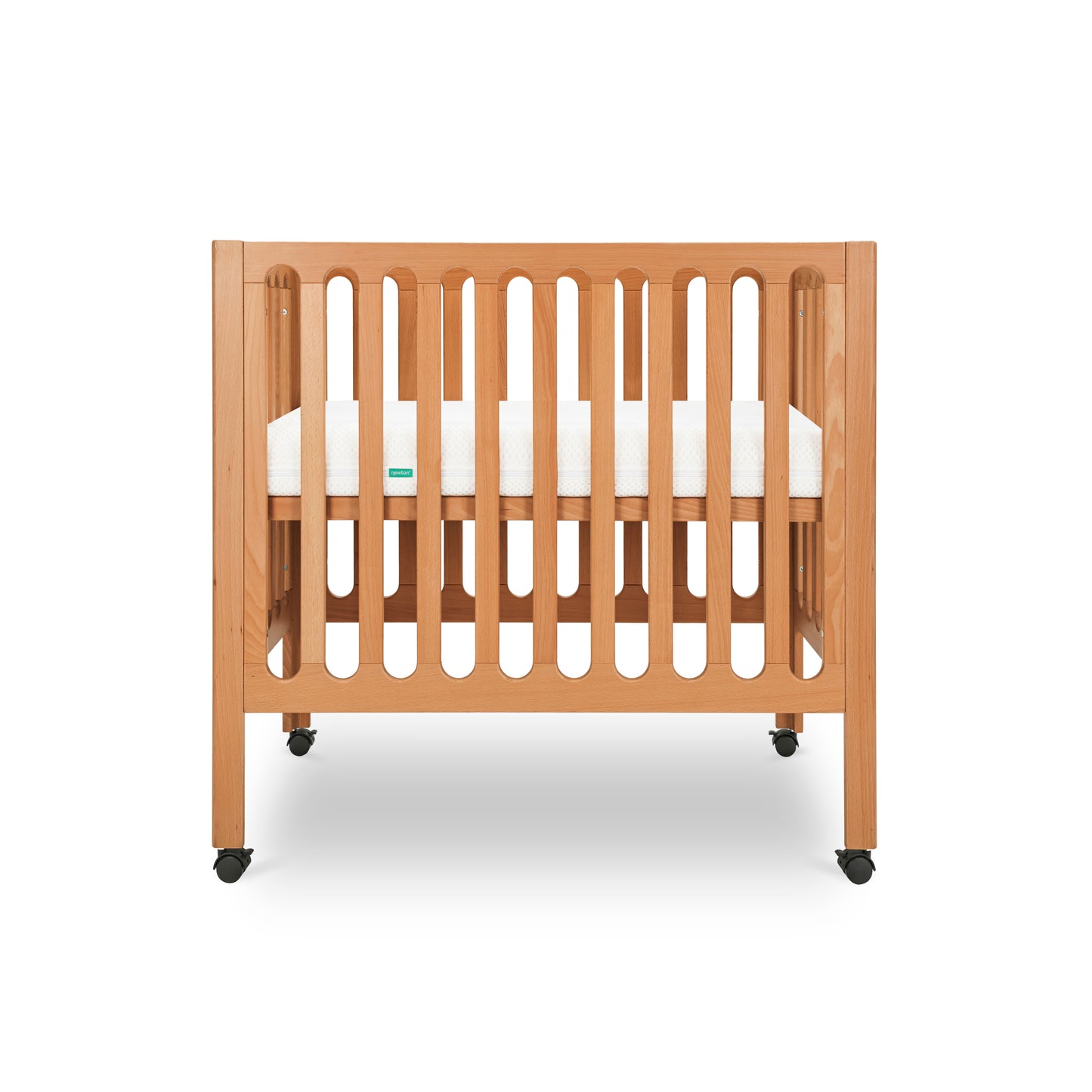 Modern wooden crib on wheels with visible mattress, isolated on a white background. 