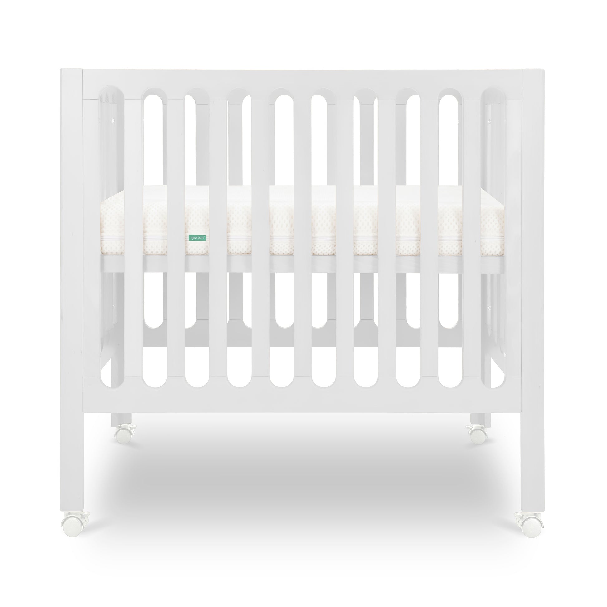 White modern crib on wheels with visible mattress, isolated on a plain background.