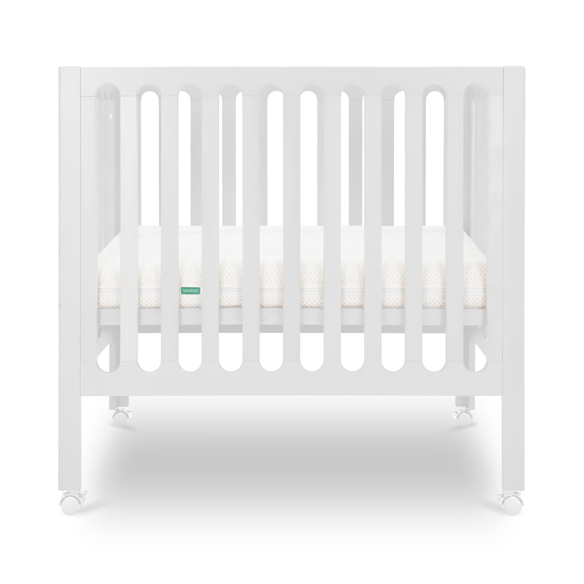 White modern crib on wheels with visible mattress, isolated on a plain background.