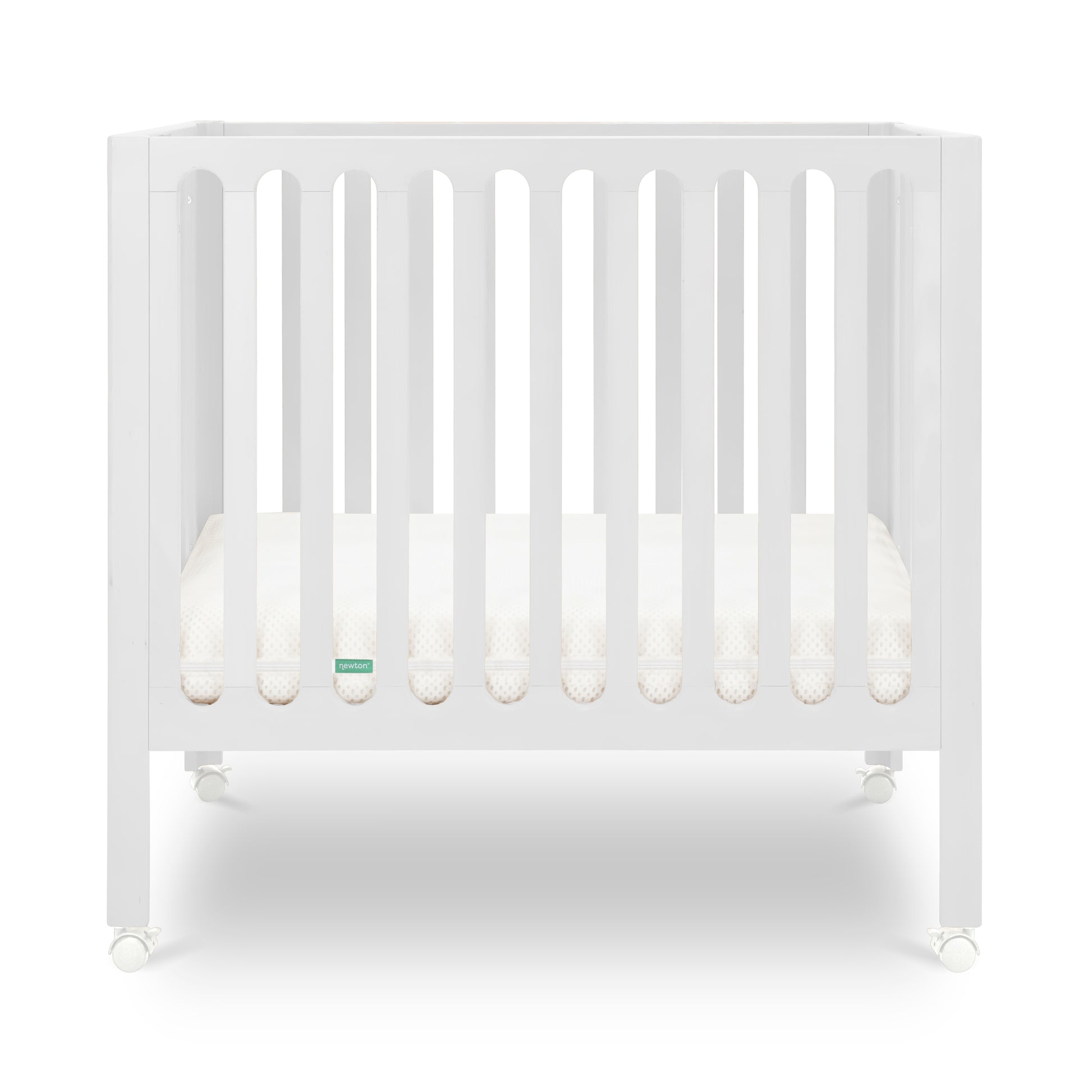 White modern crib on wheels with visible mattress, isolated on a plain background.