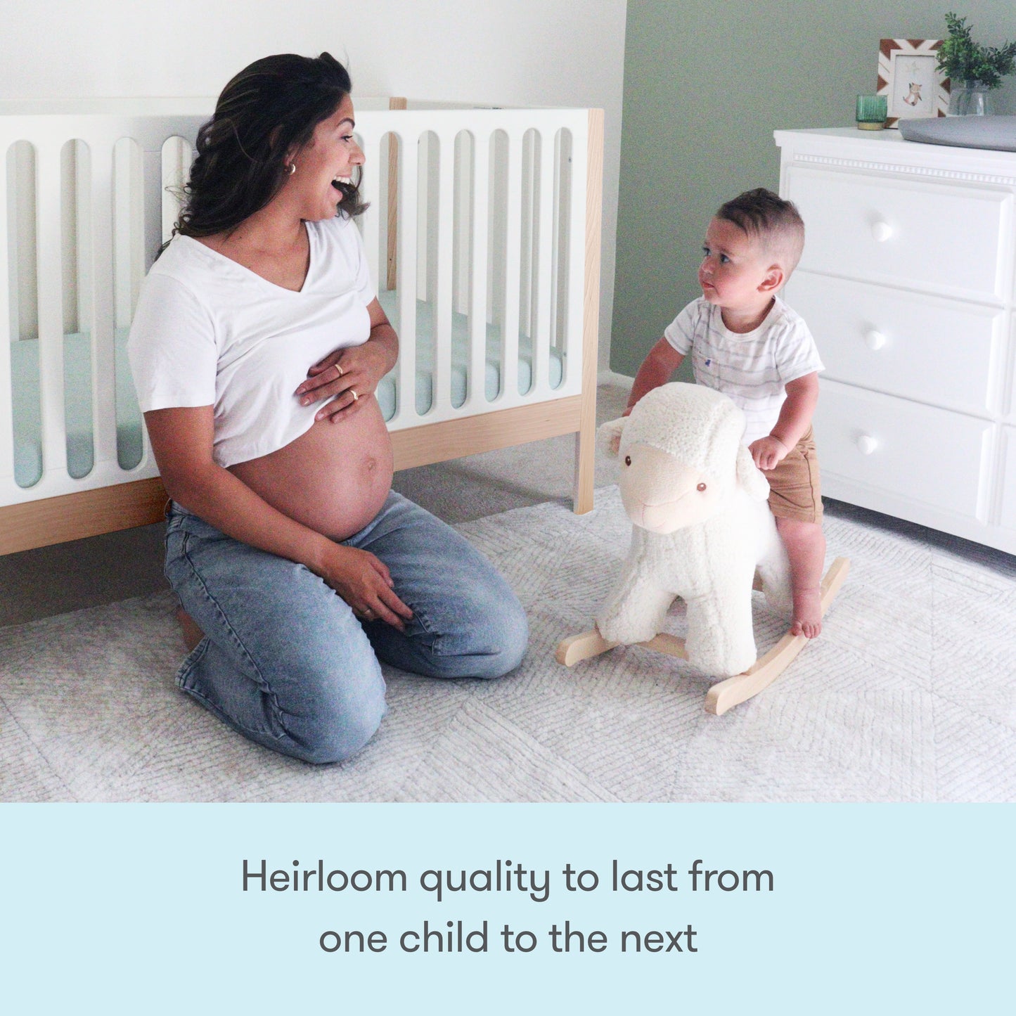 A pregnant woman smiles at a toddler on a plush rocking sheep in a bright nursery with the Newton Galileo Convertible Crib by Newton Baby. Text reads: Heirloom quality to last from one child to the next.