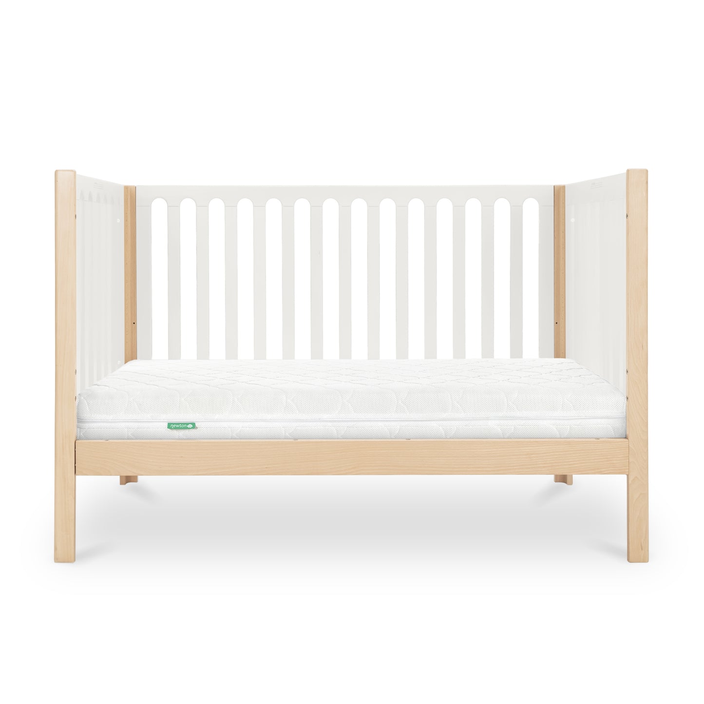 The Newton Galileo Convertible Crib by Newton Baby features natural beech wood legs, white slatted sides, and a white mattress. This 3-in-1 crib’s sleek, minimal design makes it ideal for any modern nursery.