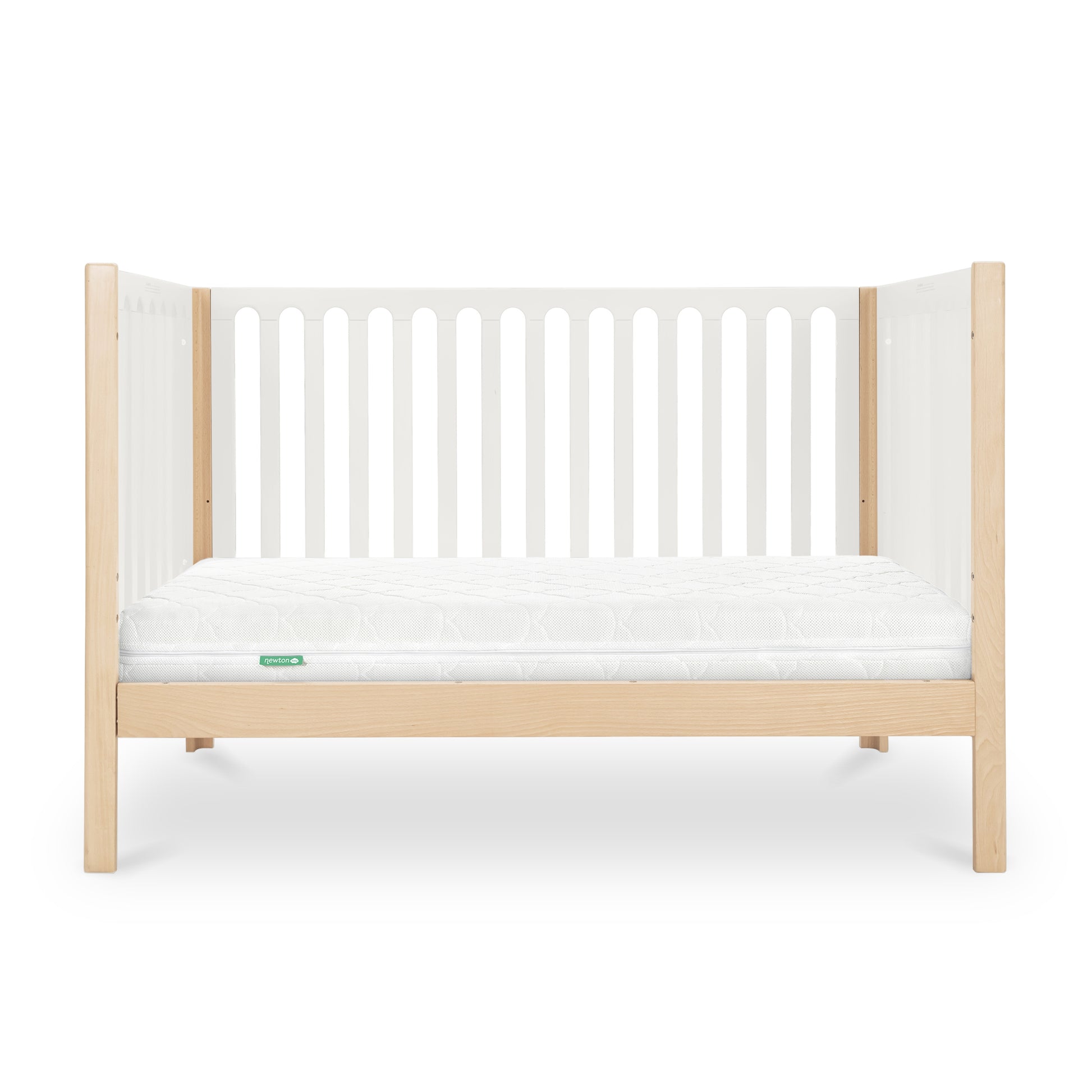 The Newton Galileo Convertible Crib by Newton Baby features natural beech wood legs, white slatted sides, and a white mattress. This 3-in-1 crib’s sleek, minimal design makes it ideal for any modern nursery.