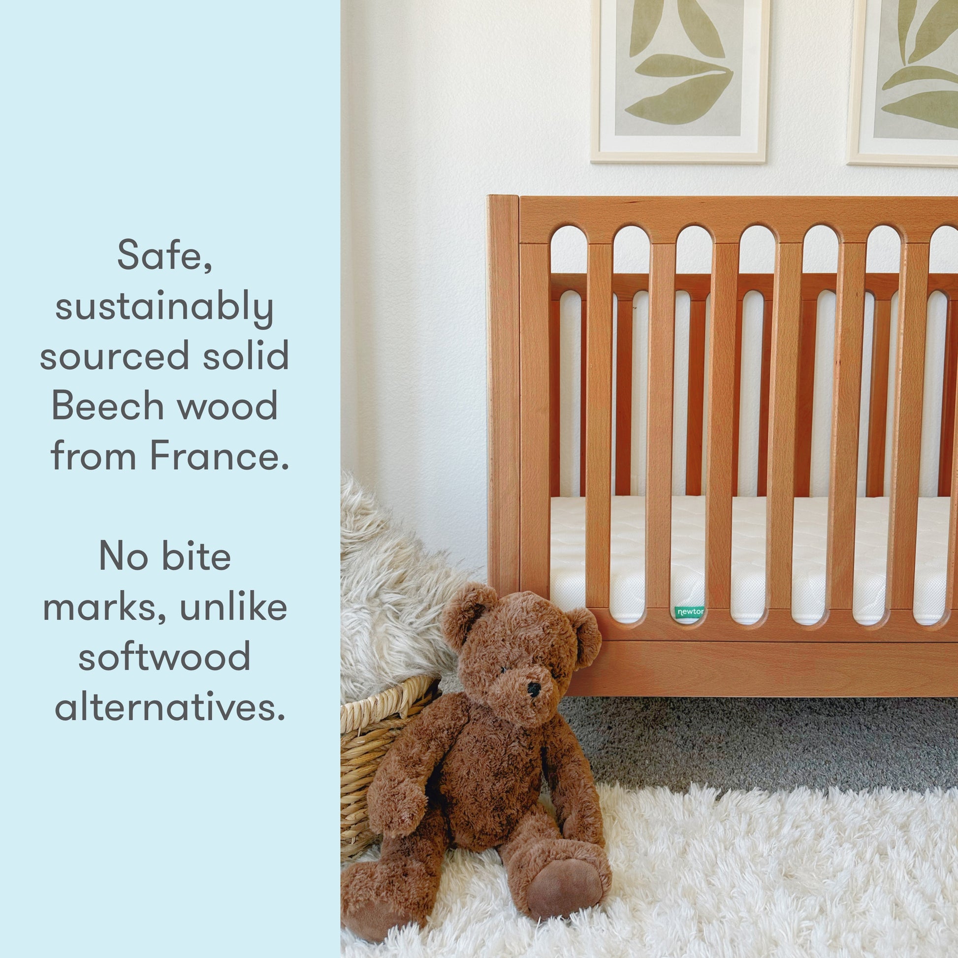 A plush teddy bear sitting beside a wooden crib with text overlay that reads "Safe, sustainably sourced solid Beech wood from France. No bite marks, unlike softwood alternatives."