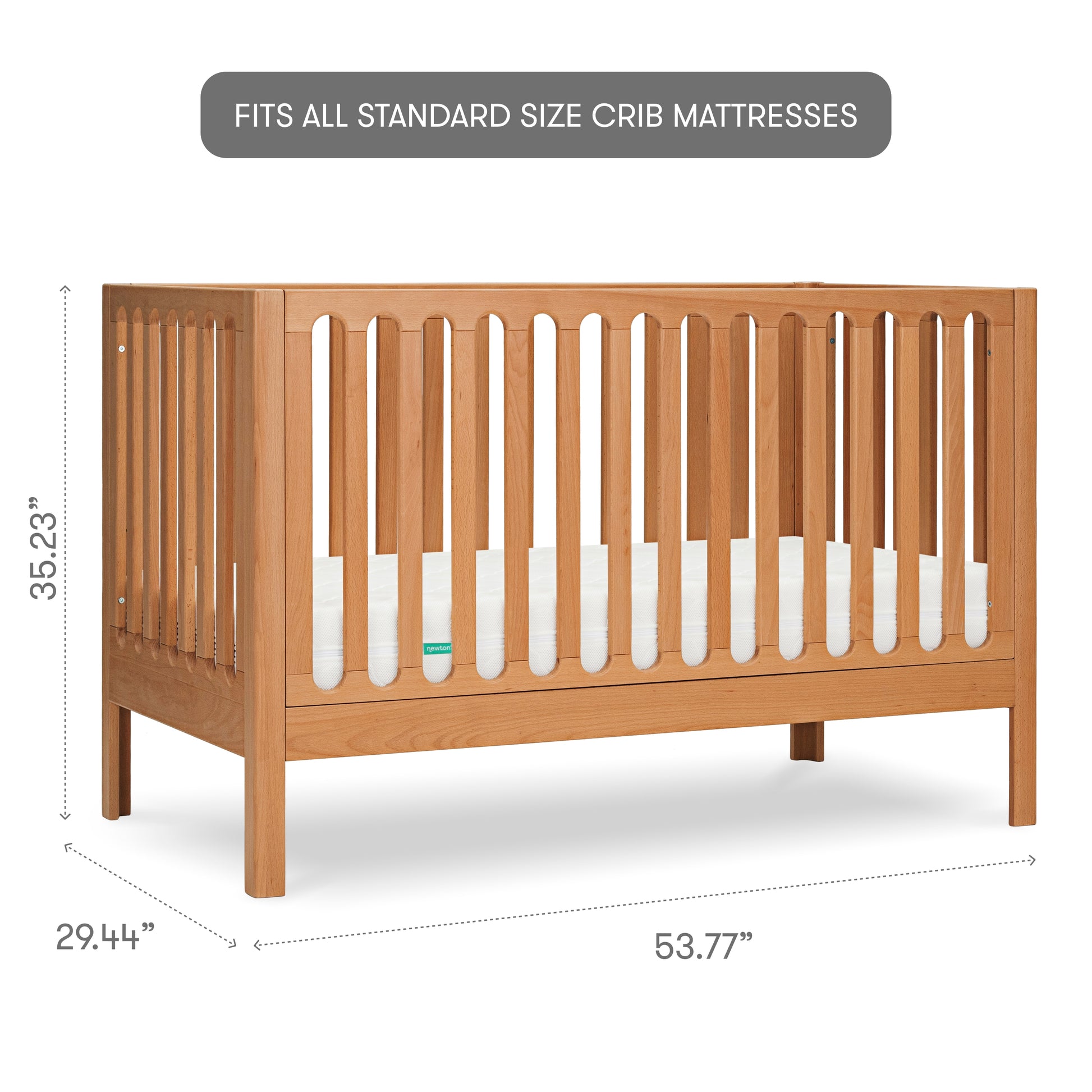 Wooden baby crib with visible brand label "newton" on the mattress, isolated on a white background, with measurements, 35.23 inches tall, 29.44 inches wide, 53.77 inches long, with text "fits all standard sized crib mattresses"
