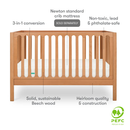 A wooden baby crib featuring 3-in-1 conversion, non-toxic and safe materials, made from solid, sustainable beech wood, with a PEFC certification logo on the right side. with text "newton standard crib mattress sold seperately"