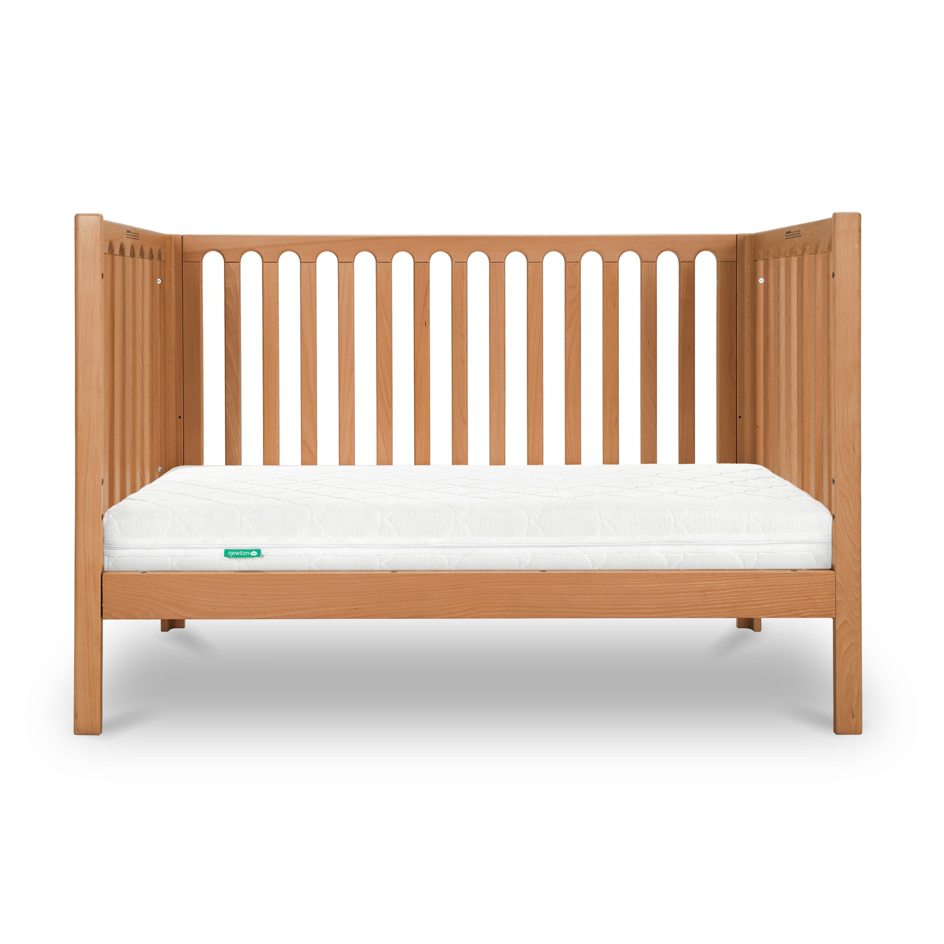 A wooden baby crib with a white Newton baby mattress.