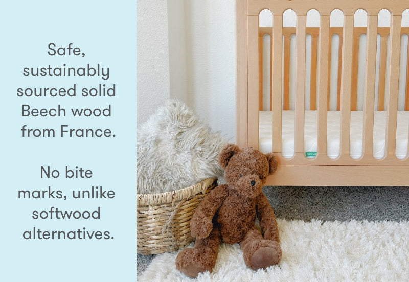 newton galileo crib in natural color in a nursery with stuffed animals, text reads "safe, sustainably sourced solid beech wood from France. No bite marks, unlike softwood alternatives.