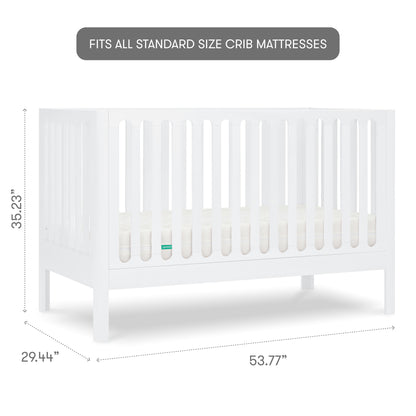The Newton Galileo Convertible Crib by Newton Baby is a white beech wood crib with slatted sides, measuring 35.23"H x 29.44"D x 53.77"W. Text above reads: Fits all standard size crib mattresses.