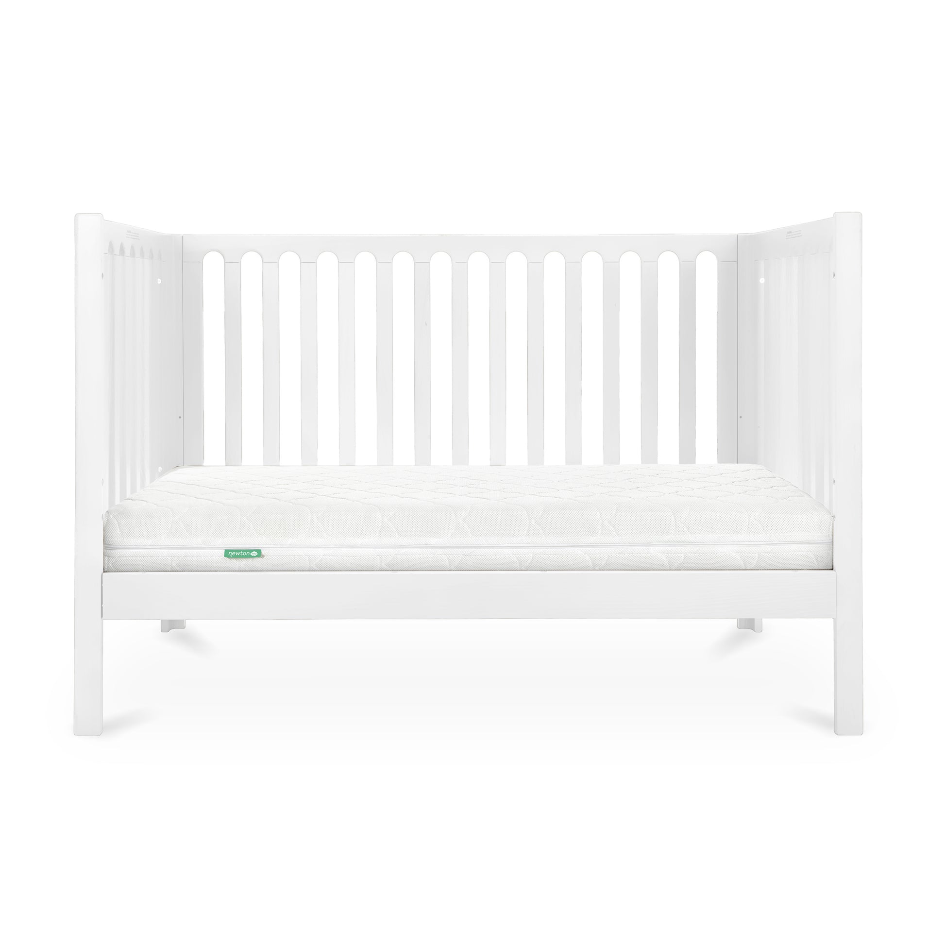 A simple white baby crib with a clean mattress displaying a small green 'Newton' logo on its corner.