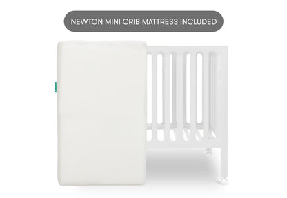 White crib mattress by a crib with slatted sides on a white background. With text "newton crib mattress included"