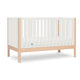 The Newton Galileo Convertible Crib by Newton Baby features natural beech wood legs, white slatted sides, a minimalist design, includes a white mattress, and converts to a toddler bed for long-lasting use.