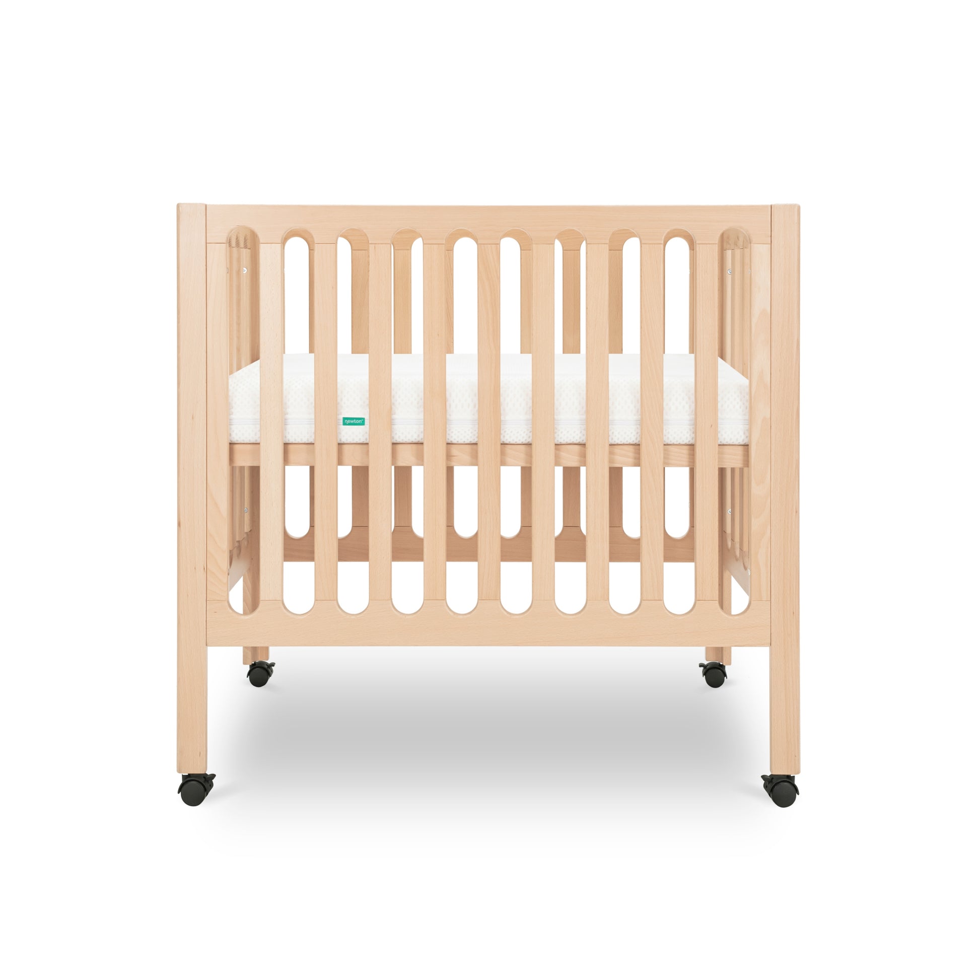 Modern wooden baby crib on wheels, featuring a white mattress and minimalist design.
