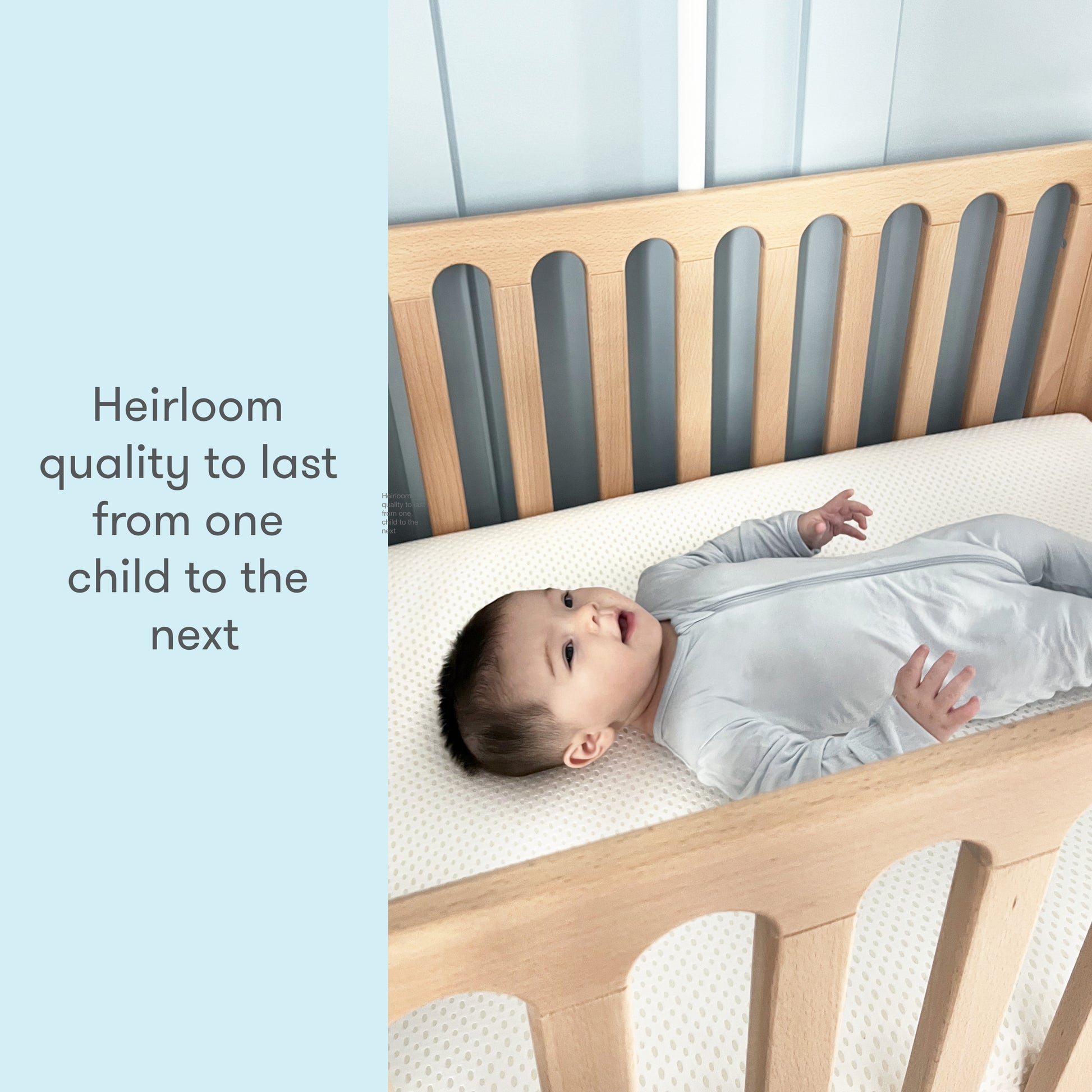 Baby in a gray sleeper lying on a crib mattress with text reading "Heirloom quality to last from one child to the next."