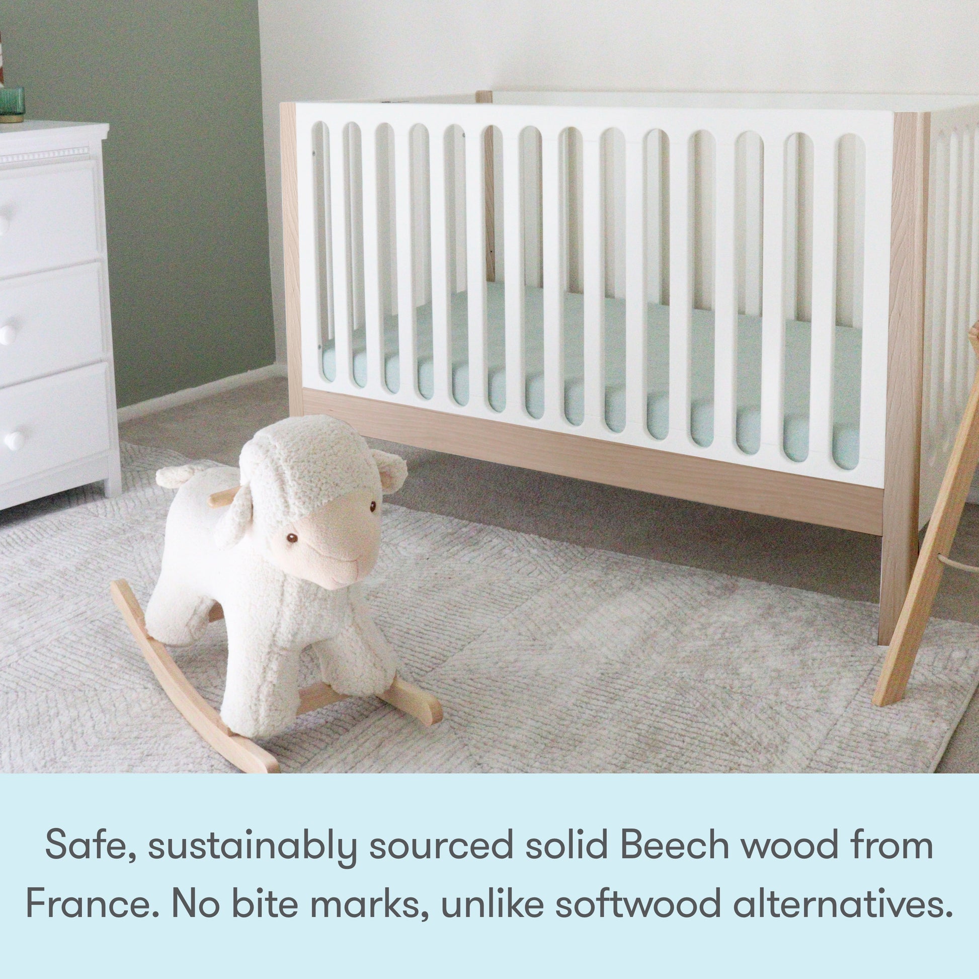 A modern nursery featuring the Newton Galileo Convertible Crib by Newton Baby (solid beech wood), a white dresser, and a plush rocking sheep on light gray carpet. Text highlights the crib’s safety, toddler bed conversion, and sustainable wood.