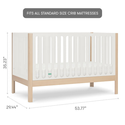 The Newton Galileo Convertible Crib by Newton Baby features modern beech wood, white slatted sides, natural legs, and a mattress. Fits all standard size crib mattresses. Dimensions: 35.23"H x 29.44"D x 53.77"W; converts to toddler bed.