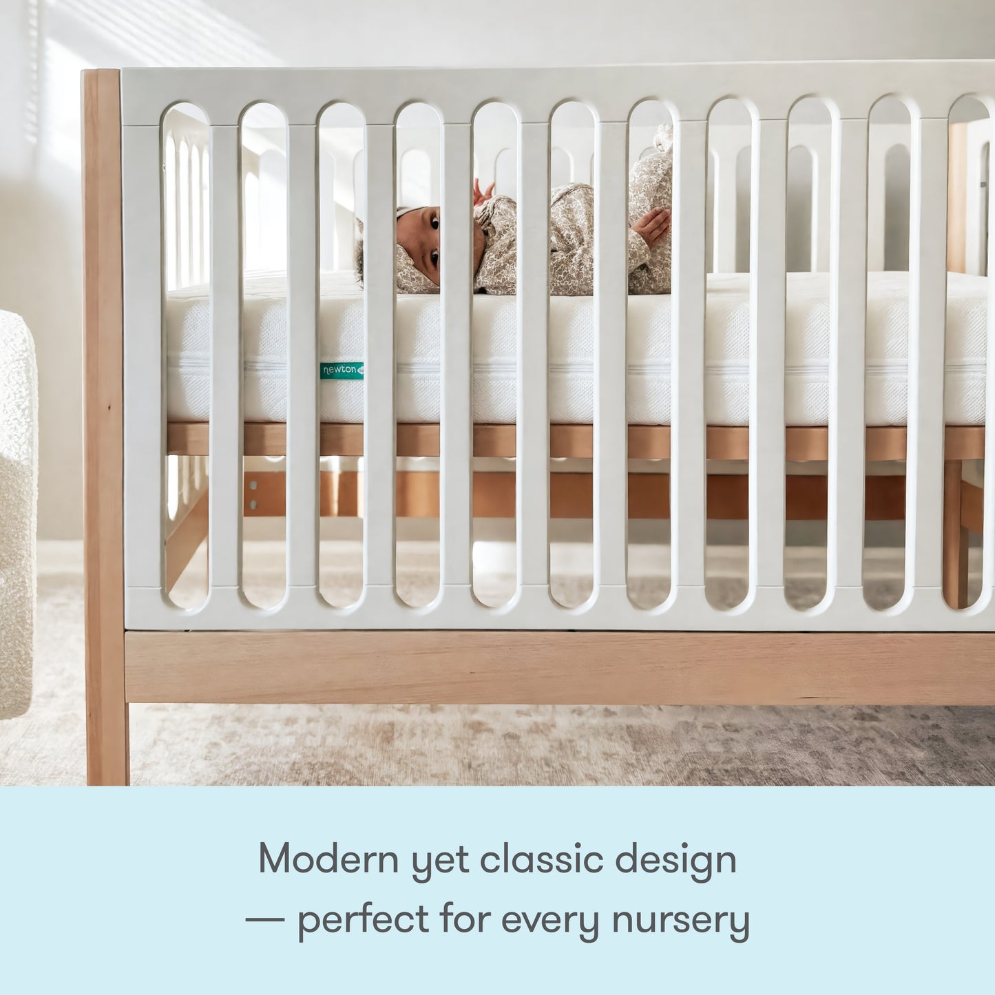 A baby rests in the Newton Baby Galileo Convertible Crib, featuring modern beech wood and white slats. Soft natural light fills the nursery. Text below reads: Stylish, timeless design—perfect for every nursery.