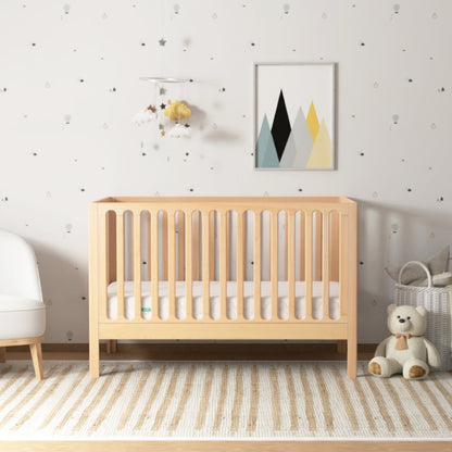 galileo crib in natural color, in nursery with newton mattress, front facing angle 999-8420-NAT