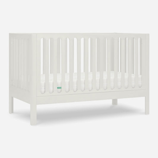 The Newton Galileo Convertible Crib by Newton Baby is a white beech wood crib with vertical slats and a flat base, shown without bedding or decorations against a plain white background.