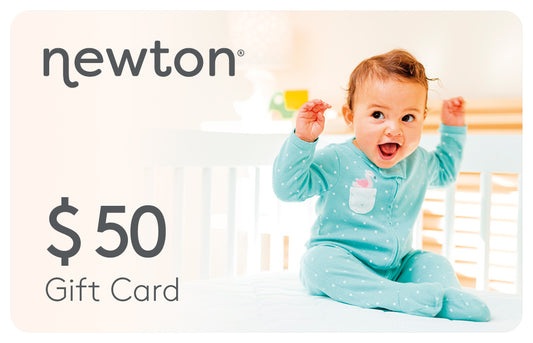 Excited baby sitting in a crib wearing a blue bodysuit, paired with a Newton $50 Gift Card promotion. GIFT50