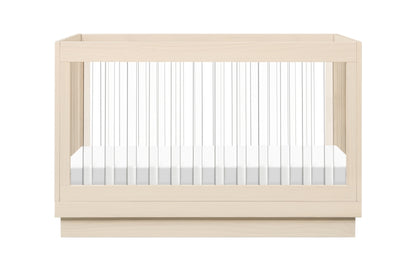 Modern wooden baby crib with a white mattress, isolated on a white background.