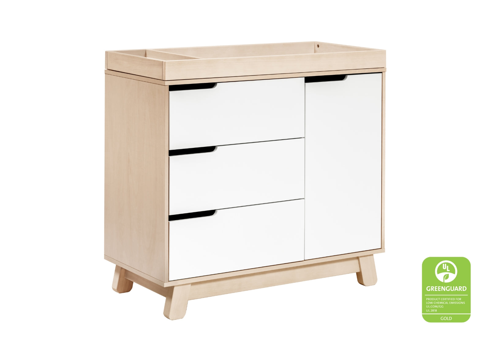 Modern nursery dresser with a combination of drawers and a cabinet door, featuring a light wood finish and a GREENGUARD Gold certification logo.