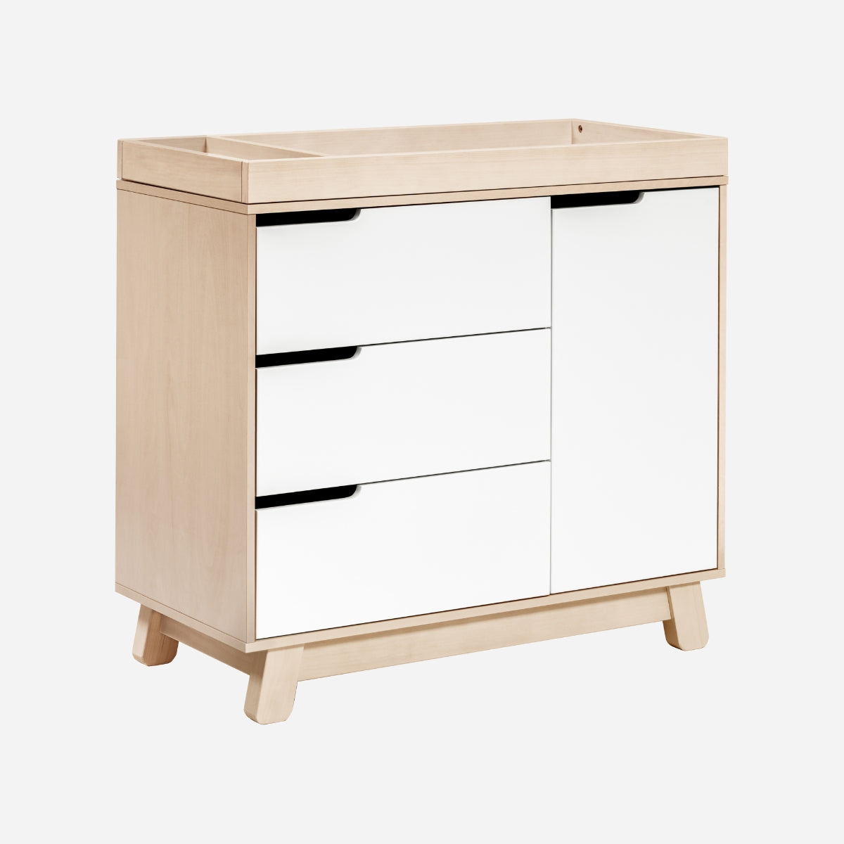 Modern baby changing table with three drawers on the left and a cabinet on the right, crafted in light wood with black handles.