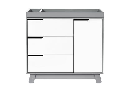 Modern gray and white baby changing table with three drawers and a cabinet.